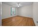 Spacious bedroom with modern ceiling fan and stylish wood-look flooring at 710 Antonia Ln, The Villages, FL 32159