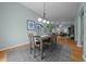 Dining area featuring a modern light fixture, gray rug, and comfortable seating, ideal for Gathering meals at 710 Antonia Ln, The Villages, FL 32159