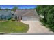 Charming single-story home with a manicured lawn and a spacious two car garage at 710 Antonia Ln, The Villages, FL 32159