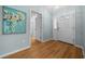 Inviting foyer with a glass front door, wood-look flooring, and a painting at 710 Antonia Ln, The Villages, FL 32159