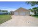 Beautifully landscaped single-story home with a spacious two-car garage and decorative driveway at 710 Antonia Ln, The Villages, FL 32159