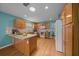 Spacious open kitchen featuring granite countertops, wood cabinets, and modern appliances at 710 Antonia Ln, The Villages, FL 32159