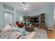 Warm living room featuring a ceiling fan, wood floors, and comfortable seating, perfect for relaxation at 710 Antonia Ln, The Villages, FL 32159