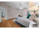 Large primary bedroom includes a ceiling fan, an ensuite bath, and ample natural light at 710 Antonia Ln, The Villages, FL 32159