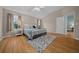 Spacious primary bedroom with wood flooring and an open view of an ensuite bathroom at 710 Antonia Ln, The Villages, FL 32159