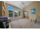 Bright sunroom with large windows, a ceiling fan, and sliding glass doors to the main living area at 710 Antonia Ln, The Villages, FL 32159