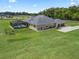 Aerial view of the property featuring a pool, screened lanai, and spacious yard at 7161 Ne 22Nd Court Rd, Ocala, FL 34479