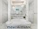 Luxury bathroom featuring a standalone tub with marble pillars, a shower, and elegant chandeliers at 7161 Ne 22Nd Court Rd, Ocala, FL 34479