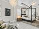 Stylish bedroom featuring a canopy bed, accent wall, decorative lighting, and modern artwork at 7161 Ne 22Nd Court Rd, Ocala, FL 34479