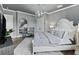 Bedroom with a large bed, stylish decor, chandelier, and view from the mirror at 7161 Ne 22Nd Court Rd, Ocala, FL 34479