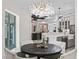 Elegant dining room with a unique light fixture, and an open view into the gourmet kitchen at 7161 Ne 22Nd Court Rd, Ocala, FL 34479