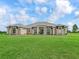 Stunning single-story home featuring lush green grass, a meticulously kept lawn and a symmetrical front facade at 7161 Ne 22Nd Court Rd, Ocala, FL 34479