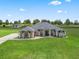 A beautifully landscaped home with a lush green lawn and well-manicured landscaping at 7161 Ne 22Nd Court Rd, Ocala, FL 34479