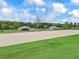 Equestrian property featuring sand arena and multiple outbuildings, surrounded by lush green fields at 7161 Ne 22Nd Court Rd, Ocala, FL 34479