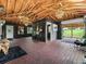 Large open flex space with brick floors and vaulted wooden ceilings at 7161 Ne 22Nd Court Rd, Ocala, FL 34479