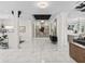 Elegant foyer features marble floors, pillars, chic décor, and seamless access to the rest of the open floor plan at 7161 Ne 22Nd Court Rd, Ocala, FL 34479