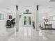Elegant foyer featuring a piano, chandeliers, decorative glass entry doors, and access to the dining area at 7161 Ne 22Nd Court Rd, Ocala, FL 34479