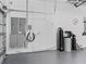 Garage interior featuring electrical panel, water treatment system, and an outlet for electric car charging at 7161 Ne 22Nd Court Rd, Ocala, FL 34479