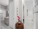Bright hallway featuring marble floors, fresh white walls, and access to the modern bathroom at 7161 Ne 22Nd Court Rd, Ocala, FL 34479
