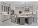 Stylish kitchen features gray cabinets, a large island with seating, and modern appliances at 7161 Ne 22Nd Court Rd, Ocala, FL 34479
