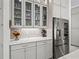 Modern kitchen boasting stainless steel refrigerator and glass-front cabinets for stylish storage at 7161 Ne 22Nd Court Rd, Ocala, FL 34479