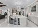 Stunning kitchen with a large island, marble floors, and modern cabinetry with display shelving at 7161 Ne 22Nd Court Rd, Ocala, FL 34479