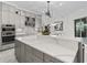 Gourmet kitchen featuring a large island with quartz countertops, designer fixtures, and stainless appliances at 7161 Ne 22Nd Court Rd, Ocala, FL 34479