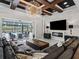 Open-concept living room with beamed ceiling, fireplace, and expansive views of the pool and outdoor area at 7161 Ne 22Nd Court Rd, Ocala, FL 34479