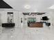 Expansive living room with marble floors, columns, modern lighting, and seamless access to the outdoor spaces at 7161 Ne 22Nd Court Rd, Ocala, FL 34479