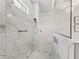 Modern shower featuring marble tiling, a glass partition, and a rain shower head at 7161 Ne 22Nd Court Rd, Ocala, FL 34479