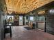 An open area featuring horse stalls and brick floors with exposed wooden ceilings at 7161 Ne 22Nd Court Rd, Ocala, FL 34479