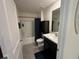 This bathroom features a single vanity, toilet and shower with a blue shower curtain at 7198 Sw 136Th Street Rd, Ocala, FL 34473