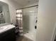 Clean bathroom featuring a shower with a striped curtain, built-in shelves, and vanity sink at 7198 Sw 136Th Street Rd, Ocala, FL 34473