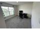 Bright bedroom with carpet flooring, a large window, and a desk for a functional workspace at 7198 Sw 136Th Street Rd, Ocala, FL 34473