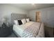 Bright bedroom with a large decorative headboard and ensuite bathroom featuring a walk-in closet at 7198 Sw 136Th Street Rd, Ocala, FL 34473