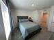Cozy bedroom featuring a gray bed frame with matching bedding and a sunlit window at 7198 Sw 136Th Street Rd, Ocala, FL 34473