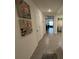 Hallway with tile flooring leading to the living area, laundry room, and bedrooms at 7198 Sw 136Th Street Rd, Ocala, FL 34473