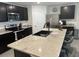 Eat-in kitchen featuring a spacious island, modern stainless steel appliances, and dark cabinets at 7198 Sw 136Th Street Rd, Ocala, FL 34473
