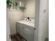 Laundry room featuring a white washer and dryer unit and wire shelving above at 7198 Sw 136Th Street Rd, Ocala, FL 34473