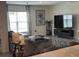 Comfortable living room with a large window, sectional sofa, and a modern entertainment center at 7198 Sw 136Th Street Rd, Ocala, FL 34473