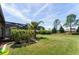 Landscaped backyard offers a serene outdoor living space with a variety of plants and a screened enclosure at 7855 Sw 97Th Cir, Ocala, FL 34481