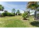 Well-maintained backyard features lush greenery, decorative landscaping, and a screened-in outdoor living area at 7855 Sw 97Th Cir, Ocala, FL 34481