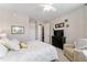 This bedroom features a comfy chair, a nice sized dresser with a TV, and a neutral color palette at 7855 Sw 97Th Cir, Ocala, FL 34481