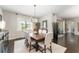Dining room with a dark wood table, seating for six, and natural light at 7855 Sw 97Th Cir, Ocala, FL 34481
