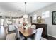Open dining room featuring a wooden table, seating for six, and seamless access to the kitchen at 7855 Sw 97Th Cir, Ocala, FL 34481