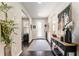 Stylish foyer with hardwood floors, modern console table, decorative accents, and an eye-catching floral display at 7855 Sw 97Th Cir, Ocala, FL 34481