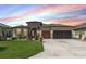 Beautiful home featuring a well-manicured lawn, three-car garage, and a welcoming arched entryway at 7855 Sw 97Th Cir, Ocala, FL 34481