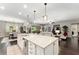 Spacious kitchen island perfect for entertaining, with pendant lighting, and an open-concept design to the living area at 7855 Sw 97Th Cir, Ocala, FL 34481