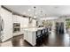 Bright kitchen features a large island with seating, stainless steel appliances, and plenty of storage space at 7855 Sw 97Th Cir, Ocala, FL 34481