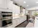 Contemporary kitchen equipped with stainless steel appliances, granite countertops, and dark wood flooring at 7855 Sw 97Th Cir, Ocala, FL 34481